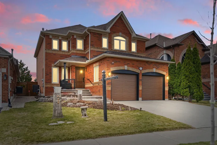 Two-storey brick home at dusk