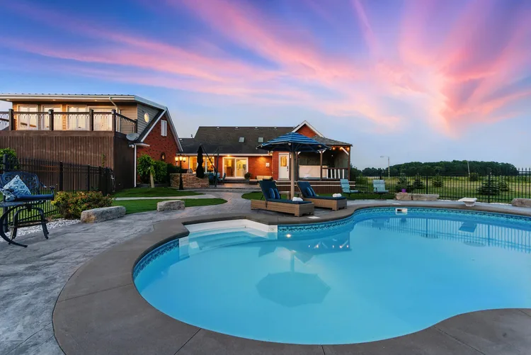 Backyard pool and patio at sunset